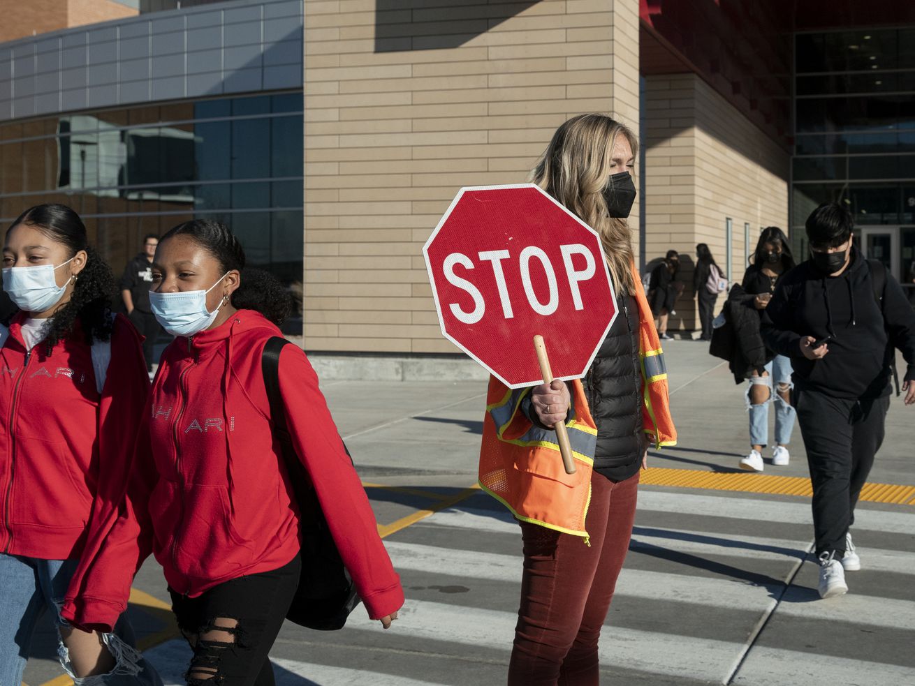 Students at Mount Jordan Middle School in Sandy wear masks on their way to school.