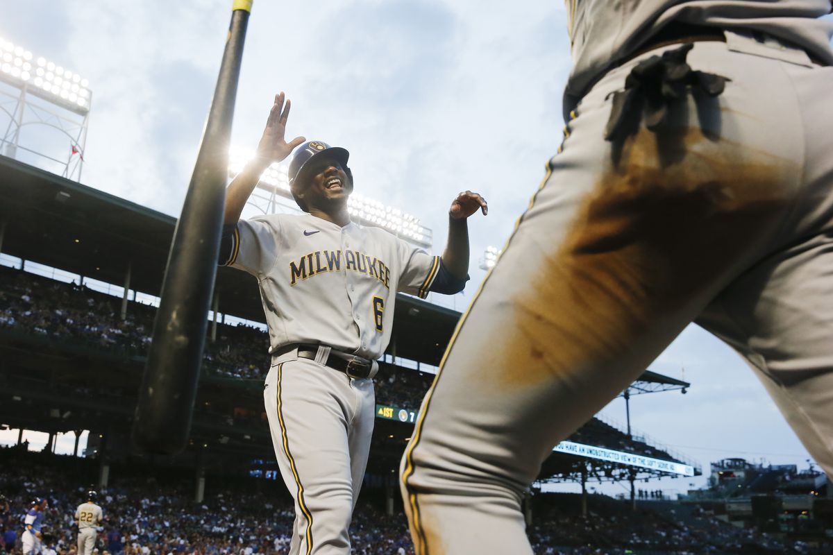 Lorenzo Cain #6 of the Milwaukee Brewers celebrates after scoring in the first inning against the Chicago Cubs at Wrigley Field on August 11, 2021 in Chicago, Illinois.