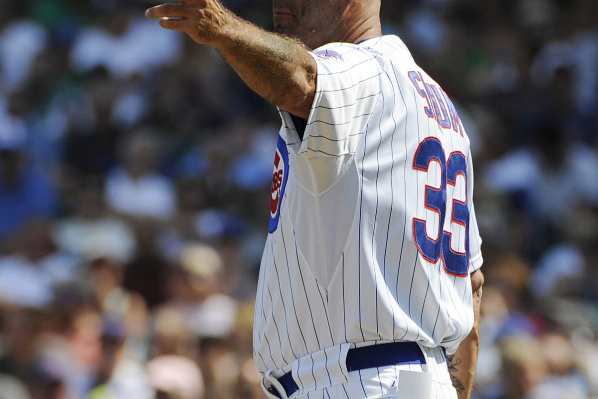 Dale Sveum, manager of the Chicago Cubs, makes a pitching change against the Colorado Rockies at Wrigley Field in Chicago, Illinois. (Photo by David Banks/Getty Images)