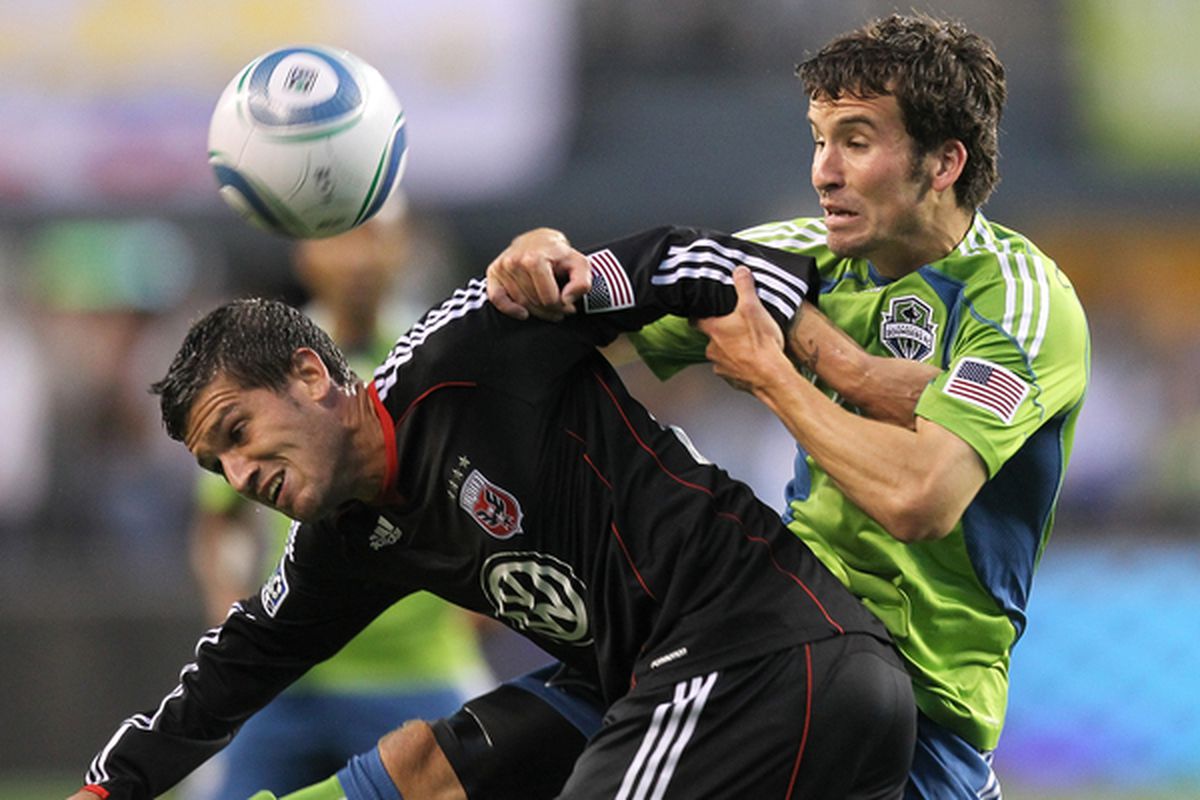 SEATTLE - JUNE 10:  Santino Quaranta #25 of D.C. United battles Nathan Sturgis #12 of the Seattle Sounders FC on June 10, 2010 at Qwest Field in Seattle, Washington. D.C. United defeated the Sounders 3-2. (Photo by Otto Greule Jr/Getty Images)
