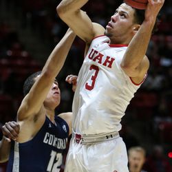Utah Utes guard Devon Daniels (3) lays it up over Concordia’s Latrell Wilson during a game at the Hunstman Center in Salt Lake City on Tuesday, Nov. 15, 2016.