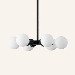 Globe light/ SCHOOLHOUSE: A contemporary take on early 20th-century lighting, this six-bulb chandelier produces nice ambient light in a high-ceilinged space. Satellite 6 Chandelier in True Black, $699; schoolhouse.com 