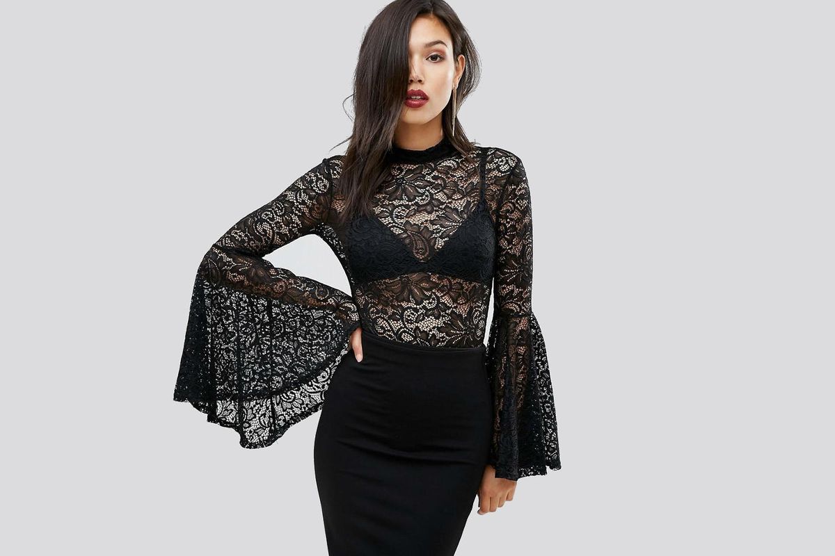 A model in a lace bodysuit with exaggerated sleeves