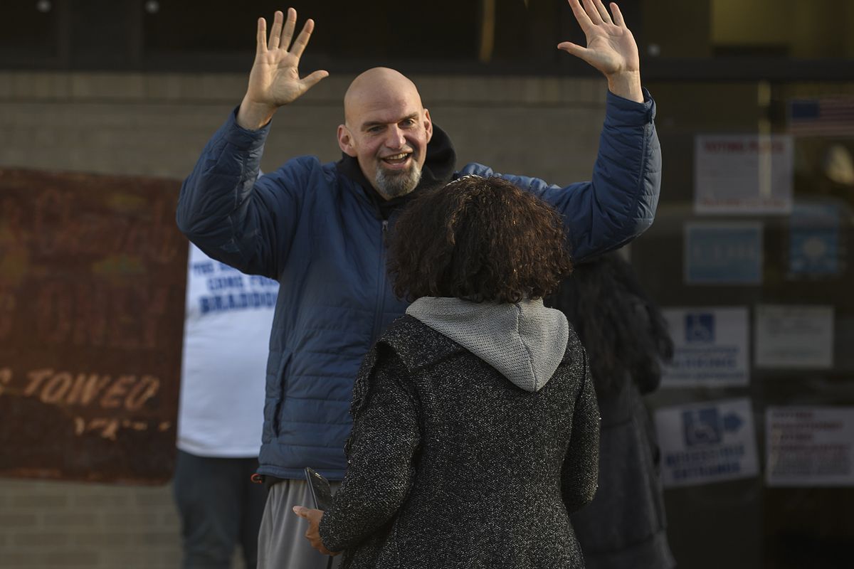Pennsylvania Democratic Senate candidate John Fetterman greets a voter as he walks to his polling place to cast his vote at the New Hope Baptist Church on November 8, 2022 in Braddock, Pennsylvania.
