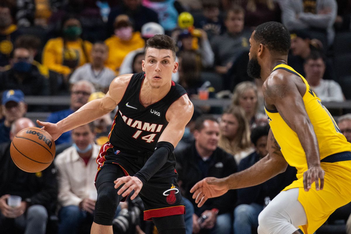 Miami Heat guard Tyler Herro (14) dribbles the ball while Indiana Pacers guard Brad Wanamaker (10) defends in the first half at Gainbridge Fieldhouse.