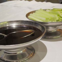 Accompaniments: Peking duck is eaten in thin pancakes with sliced cucumbers, scallions and hoisin sauce. 