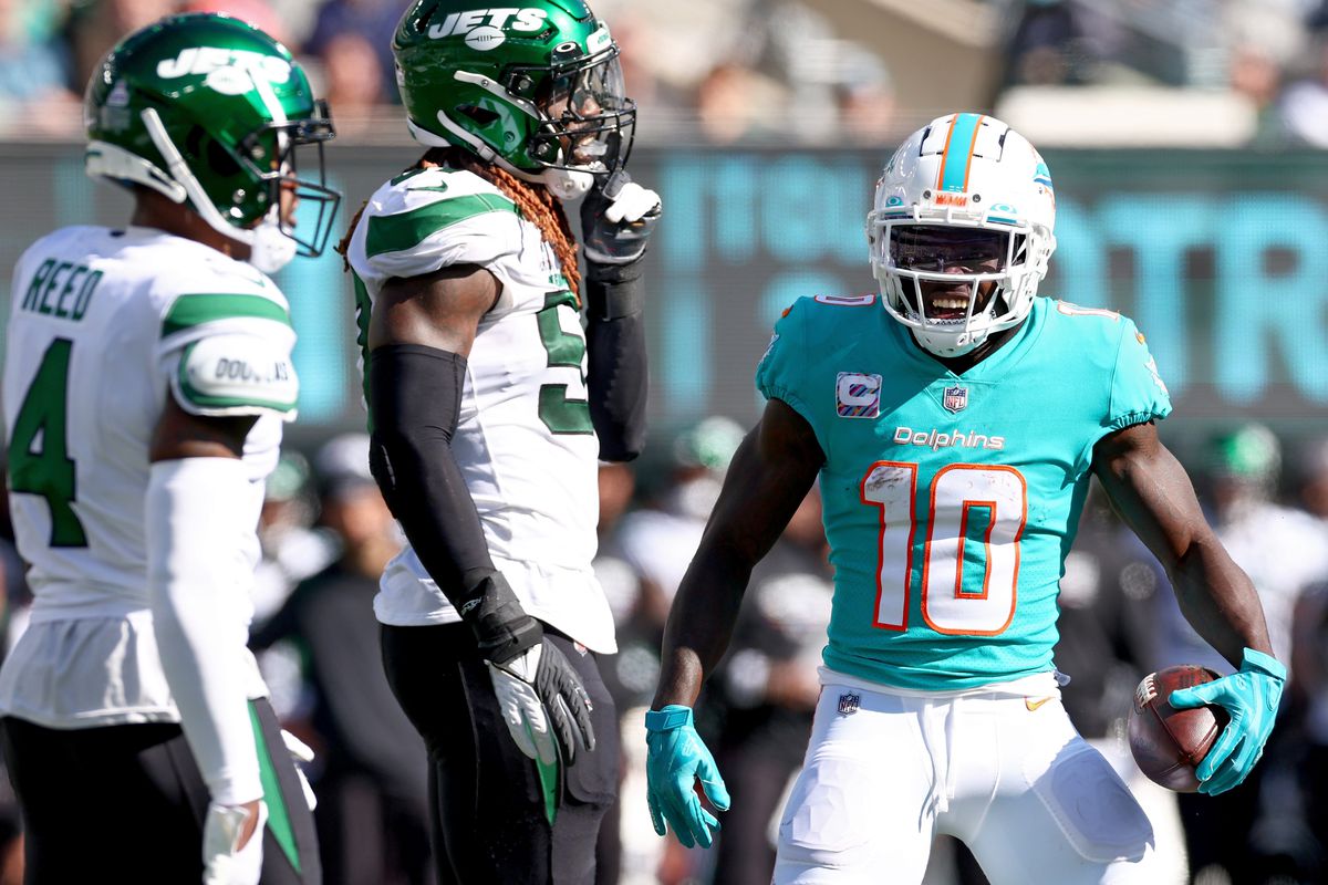 Tyreek Hill #10 of the Miami Dolphins celebrates a run against the New York Jets during the second quarter at MetLife Stadium on October 09, 2022 in East Rutherford, New Jersey.