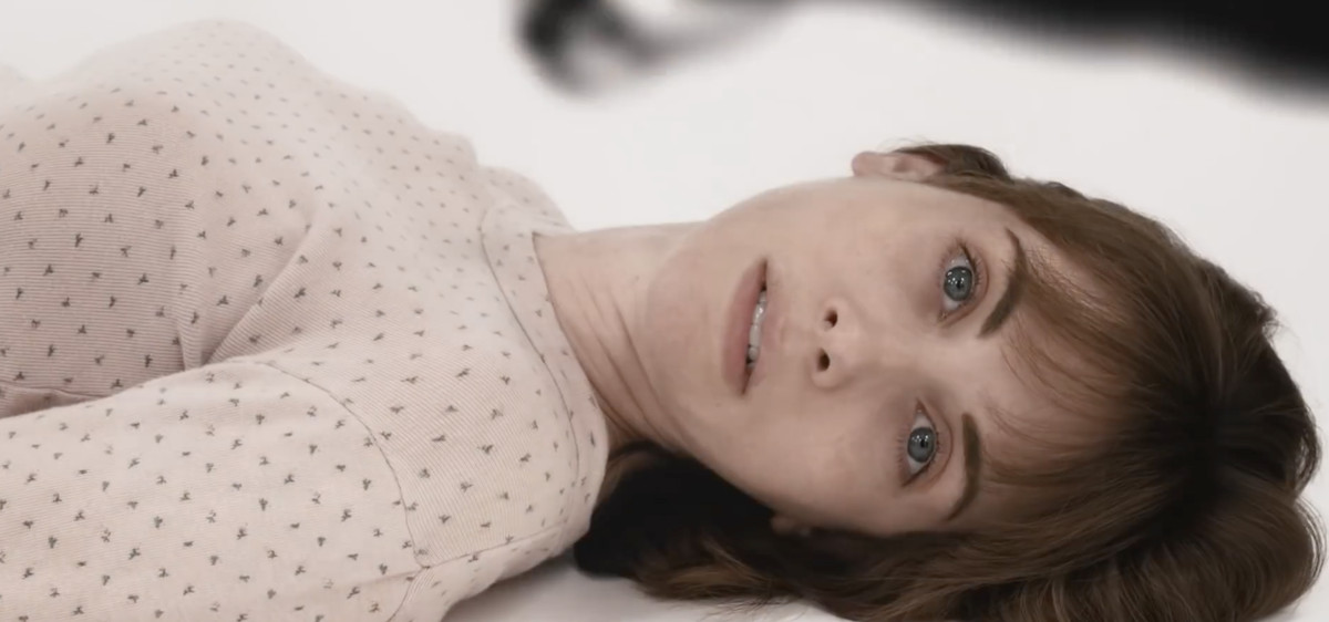 Sarah (Alison Brie) lying on the ground in Horse Girl