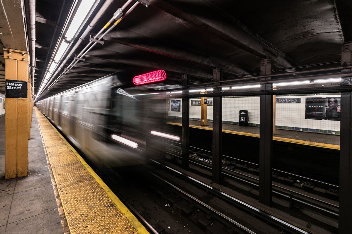 A subway train speeding through a tunnel. 