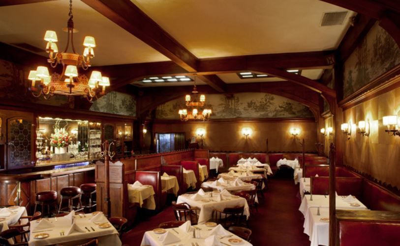 Dining room of Musso &amp; Frank in Hollywood with lights and covered tables.
