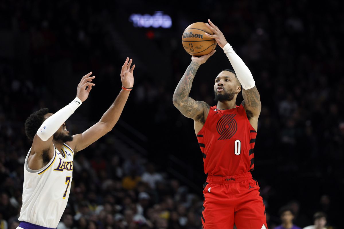 Portland Trail Blazers point guard Damian Lillard (0) shoots the ball over Los Angeles Lakers small forward Troy Brown Jr. (7) during the second half at Moda Center.