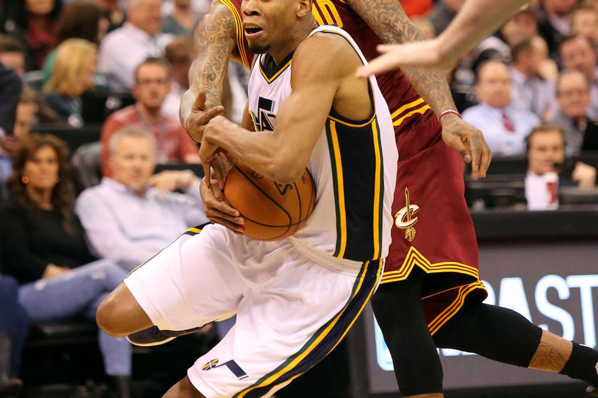 Utah Jazz guard Rodney Hood (5) moves around Cleveland Cavaliers guard J.R. Smith (5) during a basketball game at the Vivant Smart Home Arena in Salt Lake City on Monday, March 14, 2016. 
