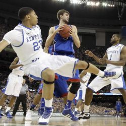 Kansas' Jeff Withey, center, grabs a rebound between Kentucky's Anthony Davis, left, and Darius Miller, right, during the first half of the NCAA Final Four tournament college basketball championship game Monday, April 2, 2012, in New Orleans.