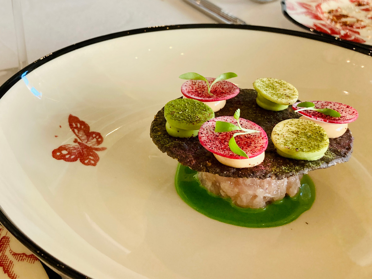 An ornate dish that looks somewhat like a mushroom with small macaron-like wedges on top. 