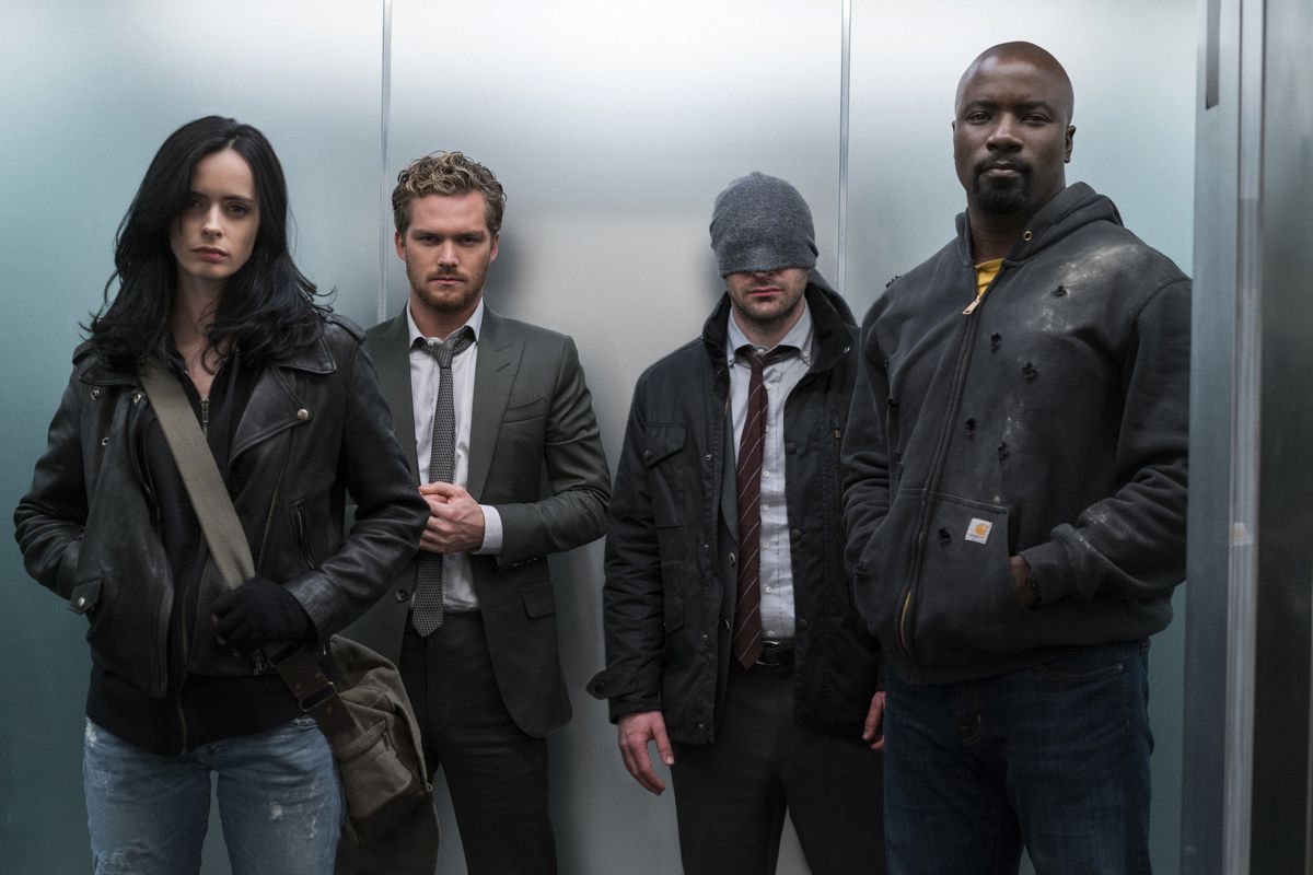 Jessica Jones, Iron Fist, Daredevil and Luke Cage stand in an elevator together in The Defenders.