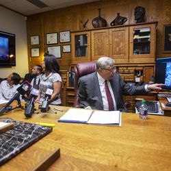 Attorney Robert Sykes shows video of Brenda Mayes' son during a press conference at Sykes' office in Salt Lake City on Tuesday, May 7, 2019. A civil rights lawsuit filed in U.S. District Court says a Davis School District bus driver, "who was driven by racial animus," closed the bus doors on on the boy's backpack and he was dragged 175 feet.