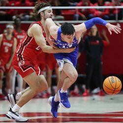 Brigham Young Cougars guard Alex Barcello (13) is fouled near the end of the game by Utah Utes guard Rollie Worster (25) in Salt Lake City on Saturday, Nov. 27, 2021. BYU won 75-64.