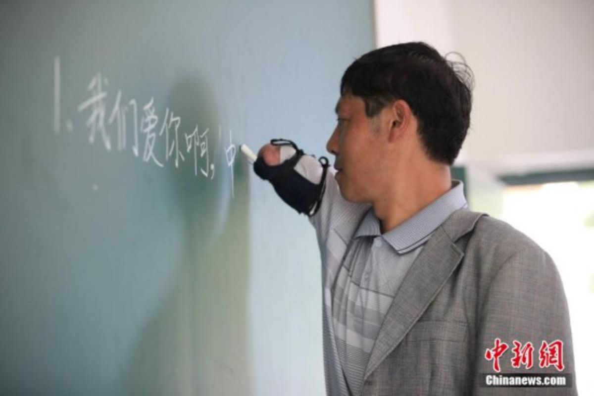 Jiang Shengfa, 41, teaches poor children in a remote Chinese village where other teachers won't work. Oh, and he has no arms.