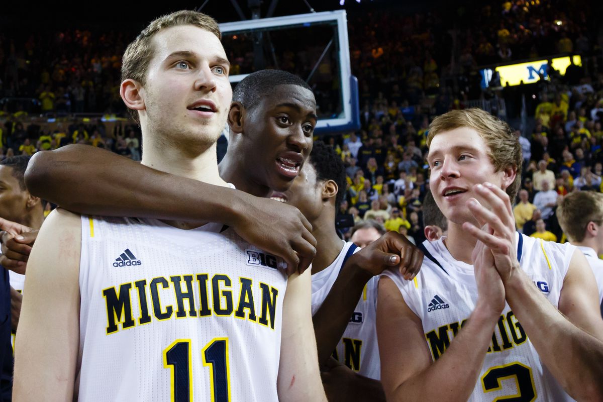 Mar 8, 2014; Ann Arbor, MI, USA; Michigan Wolverines guard Nik Stauskas (11) guard Caris LeVert (23) and guard Spike Albrecht (2) celebrate after the game against the Indiana Hoosiers at Crisler Arena.