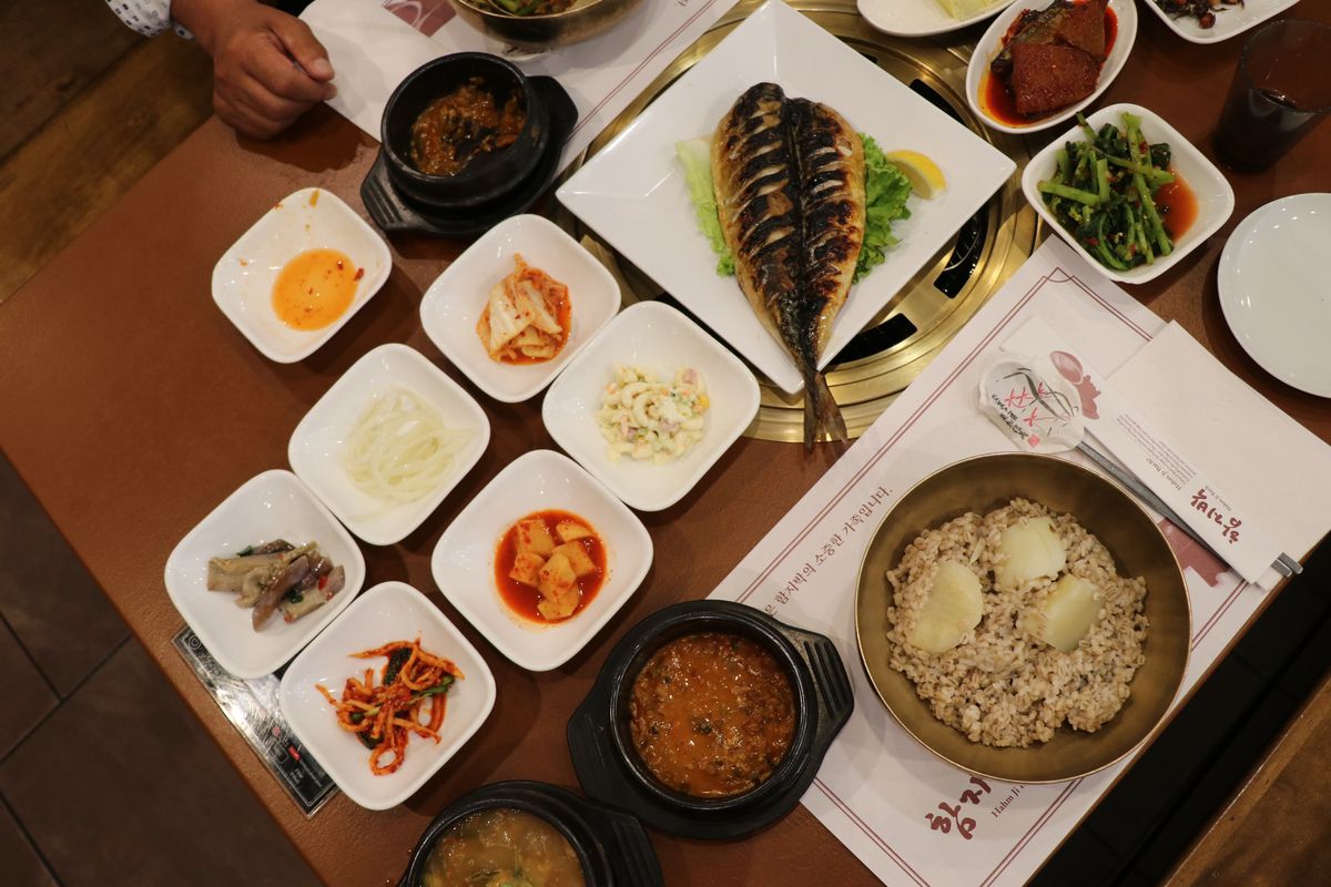 A collection of banchan and dishes on a table. 