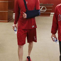 Los Angeles Angels pitcher Jered Weaver walks to a news conference to talk to the media about his injured left elbow before a baseball game against the Oakland Athletics in Anaheim, Calif. Tuesday, April 9, 2013. 