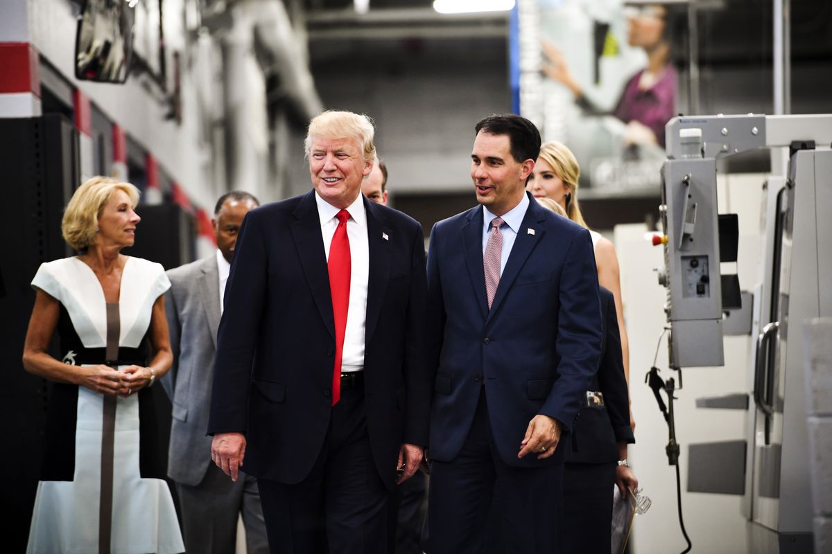 President Trump and Wisconsin Governor Scott Walker arrive for a workforce development roundtable discussion in Milwaukee, Wisconsin on June 13, 2017. 