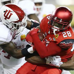 Utah Utes running back Joe Williams (28) battles for more yardage as the Utes and the Hoosiers play in the Foster Farms Bowl in Santa Clara, California, on Wednesday, Dec. 28, 2016.