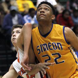In this photo taken in Chicago, on Tuesday, March 13, 2012, Simeon Career Academy's forward Jabari Parker muscles his way through a block out attempt by Evanston High School forward Matt Munro during an Illinois state basketball super-sectional game. Lola Parker, Jabari's mother, realized Jabari, had a special talent when he was in the second grade and going against fourth and fifth-graders in his father's league. She saw how advanced his footwork was, and she told her husband that their son needed to be challenged, even if that meant taking a beating against the older kids.