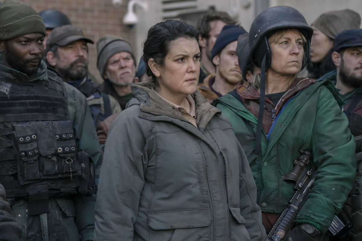 Kathleen (Melanie Lynskey) surrounded by other Hunters looking intense