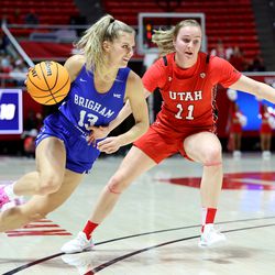 BYU Cougars guard Paisley Harding (13) drives on Utah Utes guard Brynna Maxwell (11) as Utah and BYU women compete in a basketball game at the Huntsman Center in Salt Lake City on Saturday, Dec. 4, 2021.
