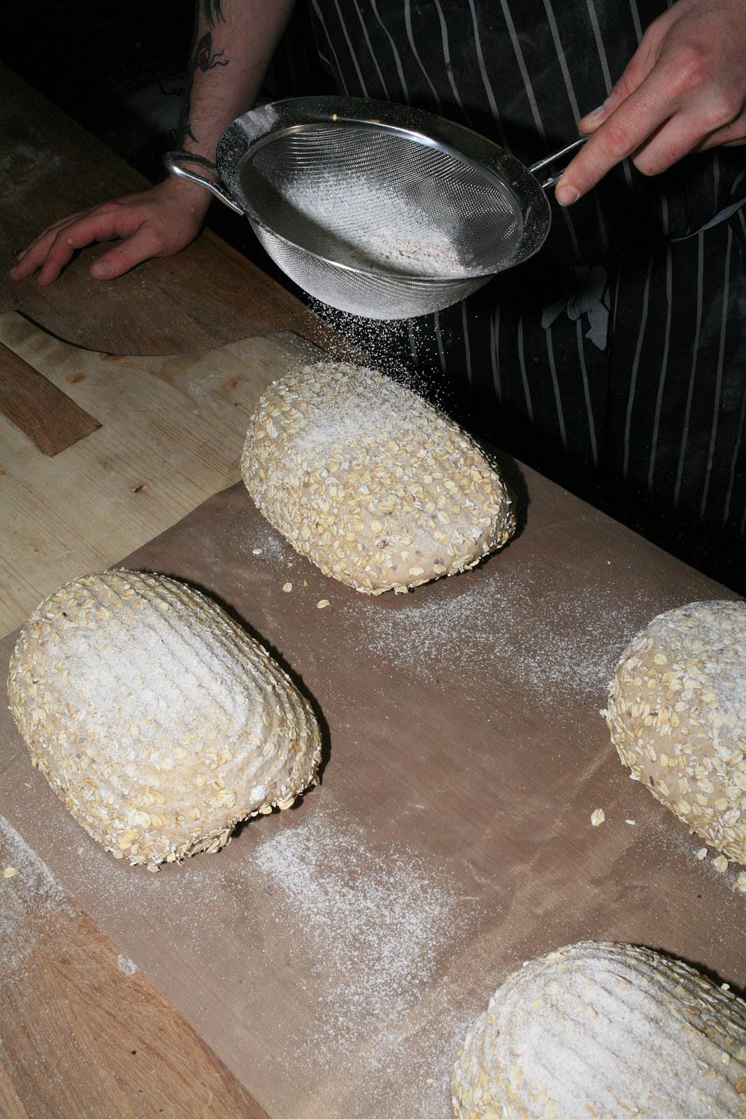 Dredging an unbaked porridge loaf in flour