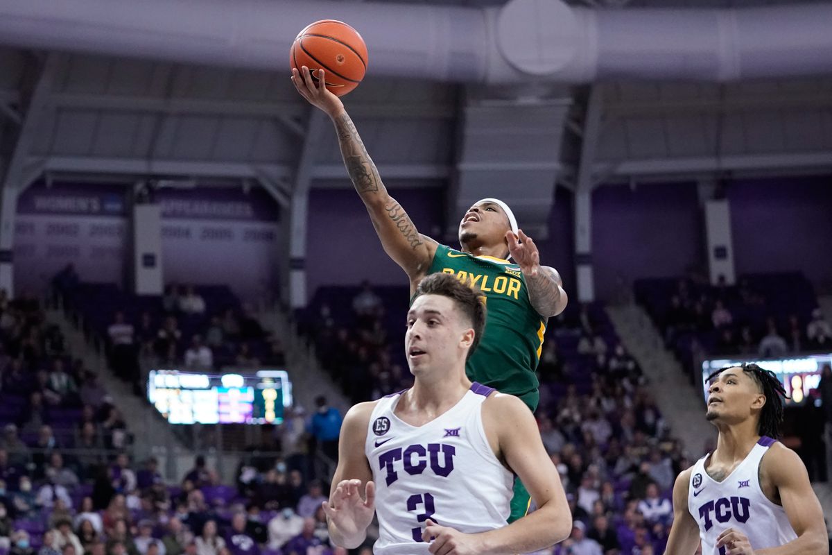 Baylor Bears guard James Akinjo (11) scores a layup over TCU Horned Frogs guard Francisco Farabello (3) during the first half at Ed and Rae Schollmaier Arena.