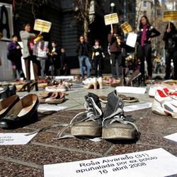 In this Thursday, July 30, 2009 file photo Shoes representing female victims of violence are displayed by protesters from the Chilean Network Against Domestic and Sexual Violence in Santiago. The sign at bottom reads in Spanish "Rosa Alvarado, 31, stabbed by ex-boyfriend, 16 April 2008." About a third of women worldwide have been physically or sexually assaulted by a former or current partner, according to the first major review of violence against women.