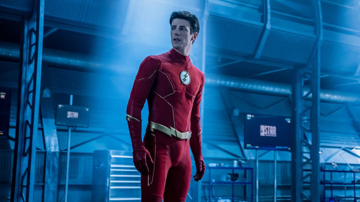 Grant Gustin as the Flash standing and looking shocked in a still from the CW show