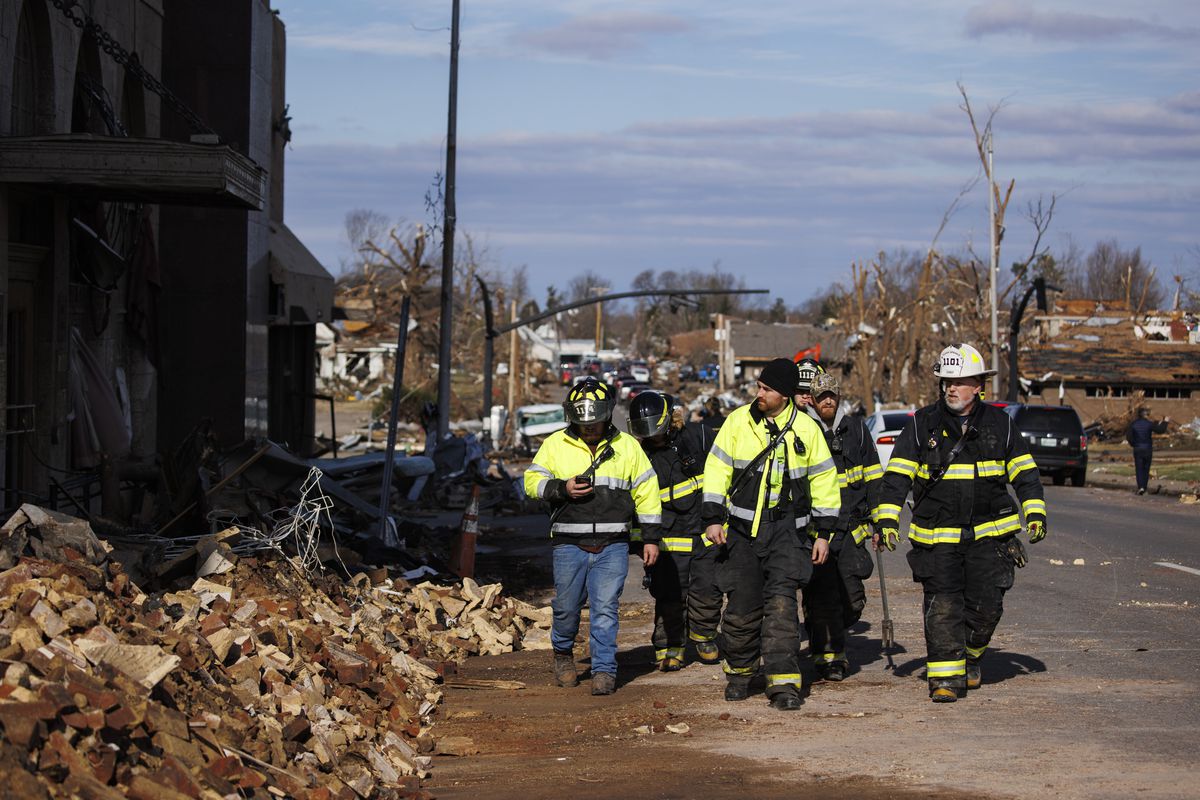 Firefighters survey tornado damages in downtown Mayfield on December 11, 2021 in Mayfield, Kentucky. 
