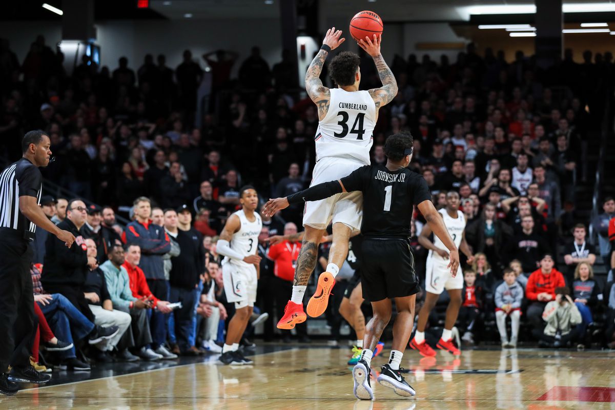 Cincinnati Bearcats guard Jarron Cumberland attempts a half court shot against UCF Knights guard Tony Johnson Jr. as time expires in the second overtime at Fifth Third Arena.&nbsp;
