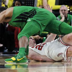 Utah Utes forward Tyler Rawson fouls out on this play with Oregon Ducks forward MiKyle McIntosh reaching for the ball during the Pac-12 basketball tournament in Las Vegas on Thursday, March 8, 2018.