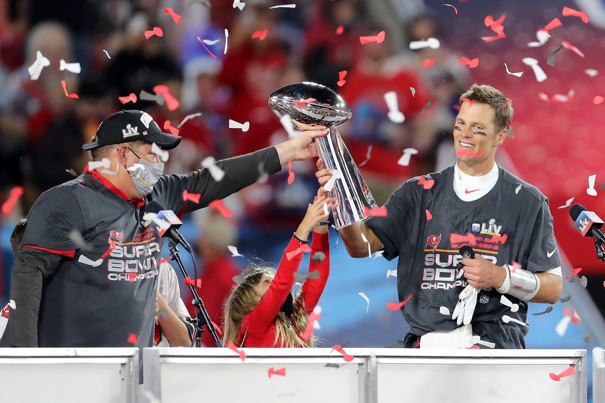 Super Bowl MVP Tom Brady (12) of the Buccaneers accepts the Lombardi Trophy from General Manager Jason Licht after the Super Bowl LV game between the Kansas City Chiefs and the Tampa Bay Buccaneers on February 7, 2021 at Raymond James Stadium, in Tampa, FL.