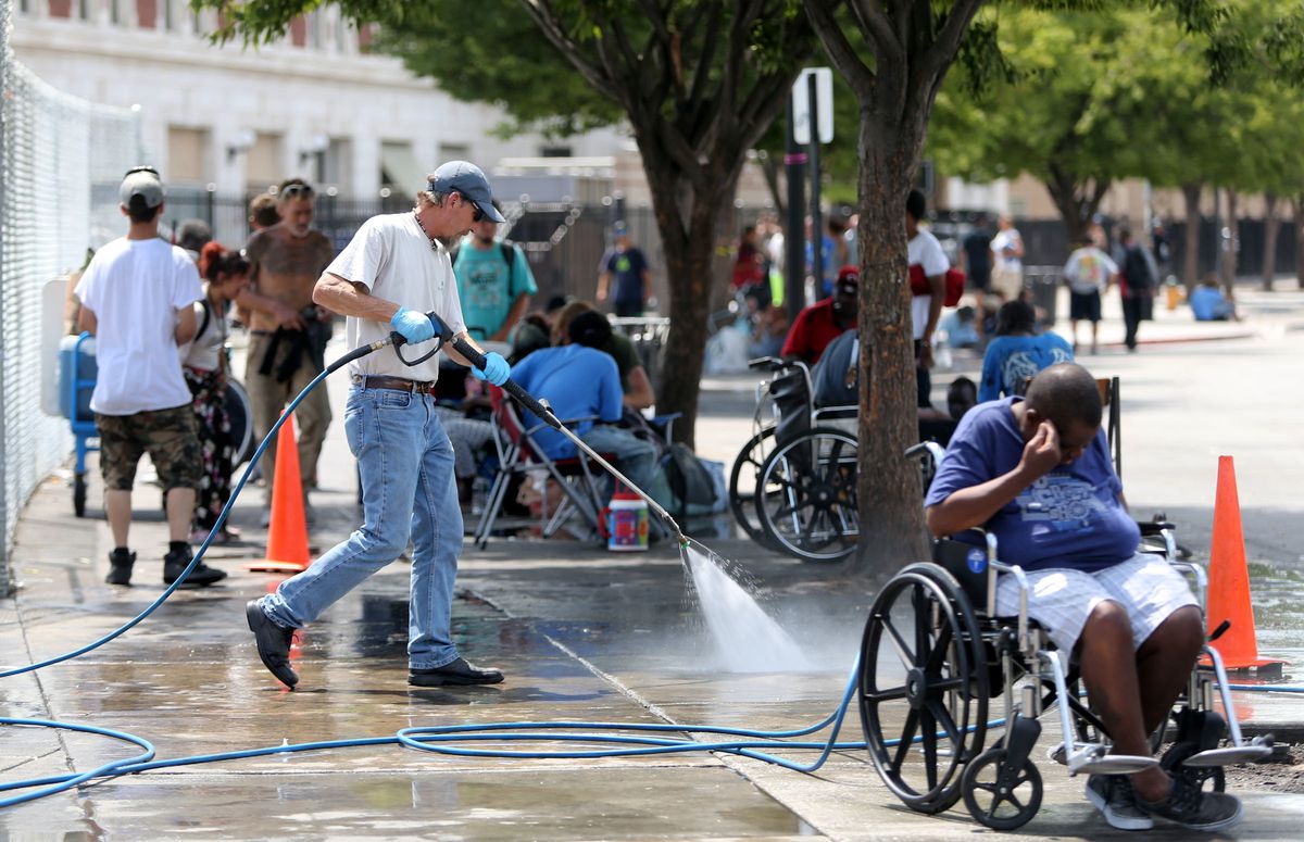 Don Allen, with Advantage Services, sprays down the sidewalks of 500 West in the Rio Grande neighborhood of Salt Lake City on Thursday, July 6, 2017. Many homeless people set up camps in the area, which are periodically cleaned up. While Allen is able to 