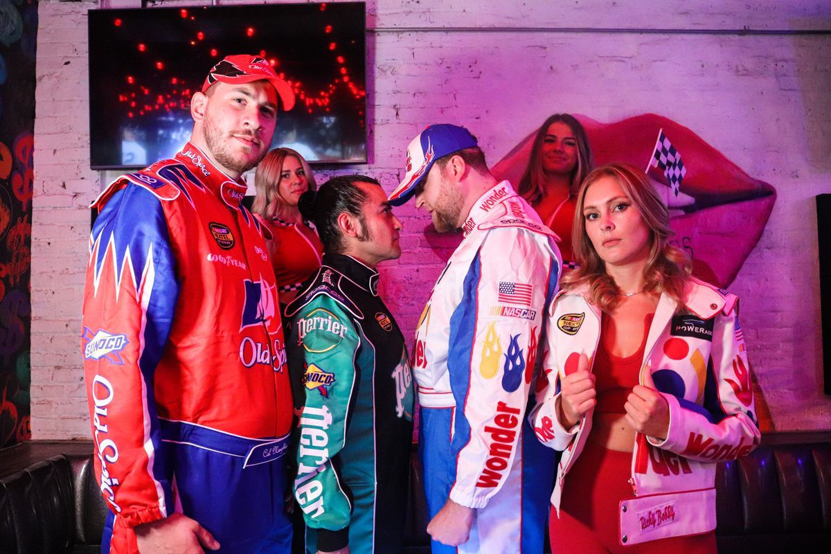 A group of people dressed in NASCAR racing costumes.