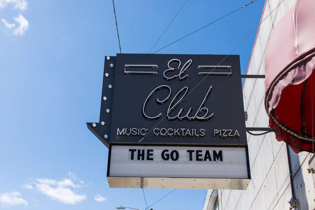 Exterior sign hangs above El Club with a marquee that reads ‘The Go Team”