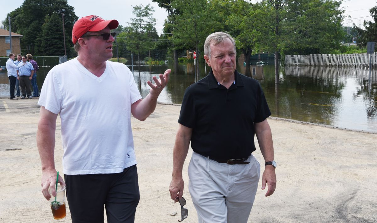Jim Oborny, left, speaks with U.S. Sen. Dick Durbin about flooding in his Gurnee neighborhood during a visit by elected officials Saturday, July 15, 2017. | Joe Lewnard/Daily Herald