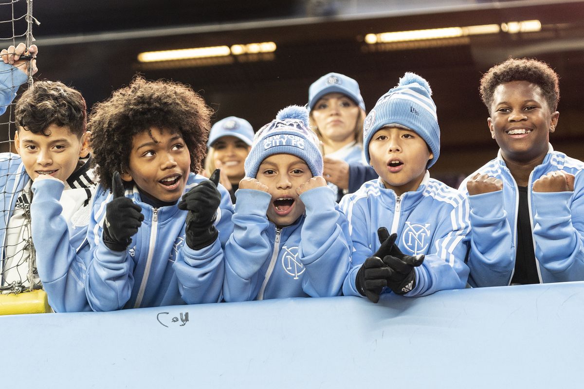 Smiling young fans of NYCFC seen during first round game of...