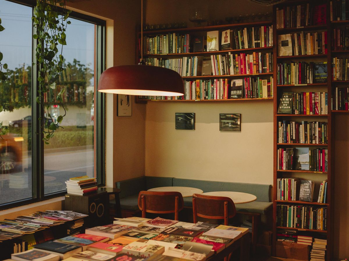 An interior shot of Paradis, showing a restaurant table surrounded by bookshelves.