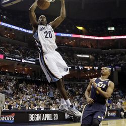 Memphis Grizzlies' Quincy Pondexter (20) dunks over Utah Jazz's Randy Foye during the first half of an NBA basketball game in Memphis, Tenn., Wednesday, April 17, 2013. 