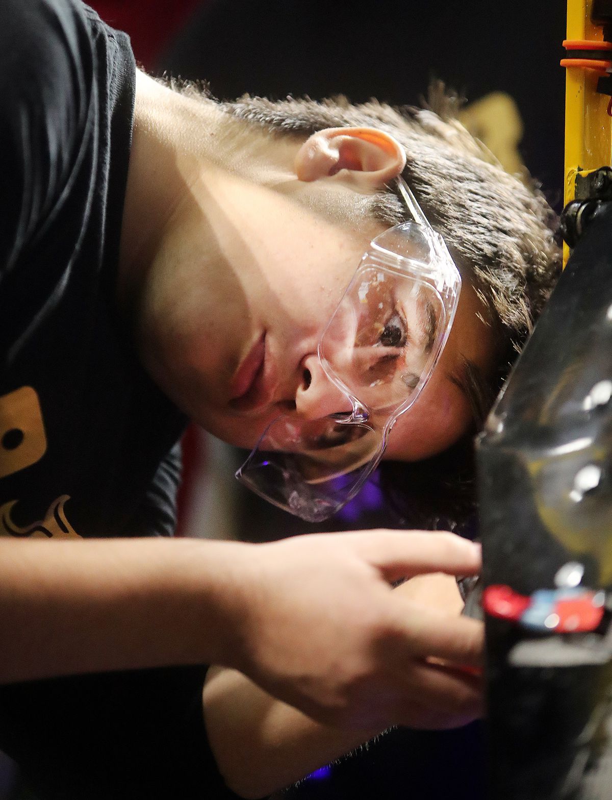 Sadam Alsavsavi joins in on working on the robot as students from Cottonwood High School work to compete in the First Robotics Competition Utah Regional event at the Maverik Center in West Valley City, Utah, on Friday, March 29, 2019.