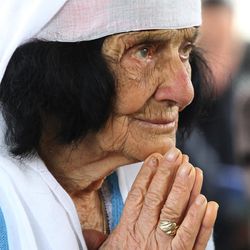 An Albanian woman prays during the mass at the cathedral in the northern city of Shkoder, Albania, celebrating the beatification of 38 Catholic martyrs executed or tortured to death during the former communist regime Saturday, Nov. 5, 2016. Albanians celebrated their beatification after Pope Francis had officially recognized as martyrs Archbishop Vincens Prenushi and 37 other priests who died in prison or were murdered in 1945-1974 by the late communist dictator Enver Hoxha's regime. 