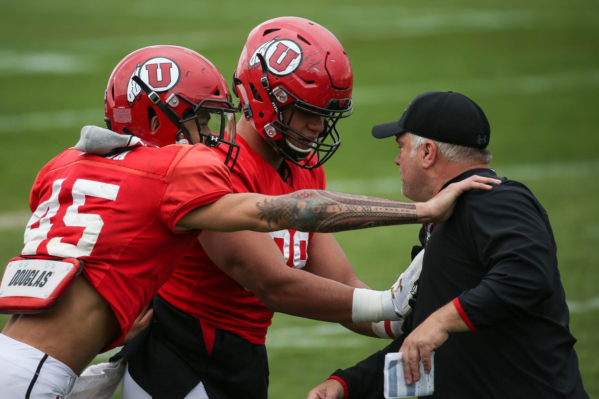 Wide receiver Samson Nacua and tight end Bapa Falemaka work with tight ends coach Freddie Whittingham during a University of Utah football practice at their outdoor practice facility in Salt Lake City on April 10, 2018.