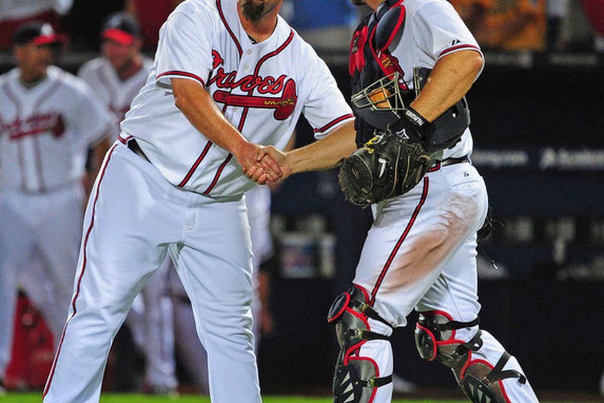 ATLANTA - JULY 15: George Sherrill #52 and David Ross #8 of the Atlanta Braves celebrate after the game against the Washington Nationals at Turner Field on July 15, 2011 in Atlanta, Georgia. (Photo by Scott Cunningham/Getty Images)