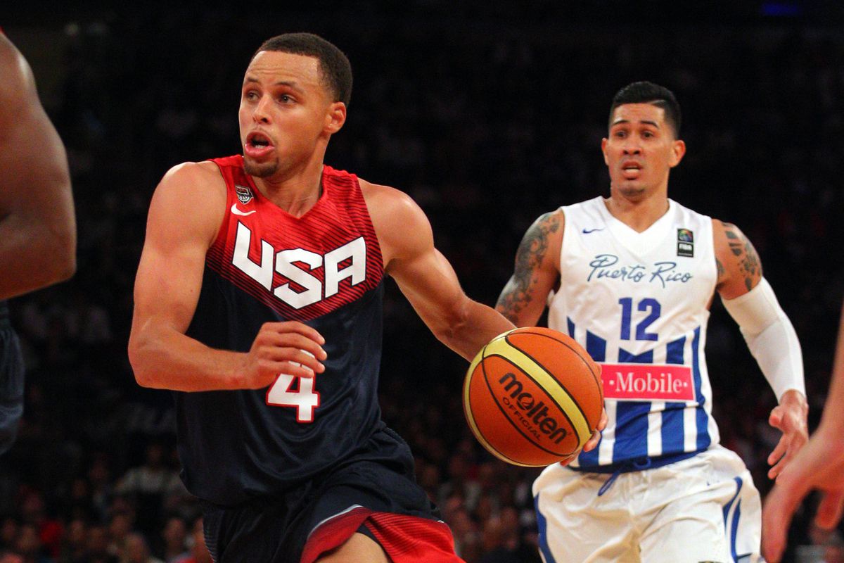 Aug 22, 2014; New York, NY, USA; United States guard Stephen Curry (4) controls the ball in front of Puerto Rico guard David Huertas (12) during the fourth quarter of a game at Madison Square Garden.